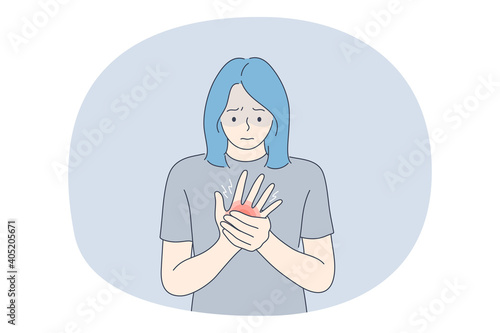 Suffering from pain in muscles, joints, injuries concept. Young unhappy woman cartoon character standing and holding painful palm feeling strong pain. Trauma, chronic illness, inflammation