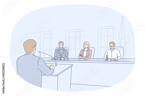 Public speaker, meeting, conference concept. Young man orator standing backwards and making presentation for board of director or listening audience group of serious people in official hall 