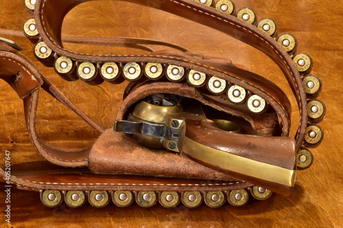 Photography Navy colt six shooter with bullets in a gunbelt.