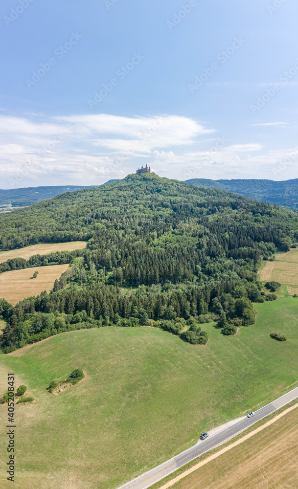 Aerial drone shot of Medival Hohenzollern Castle on hill near Stuttgart at summer noon