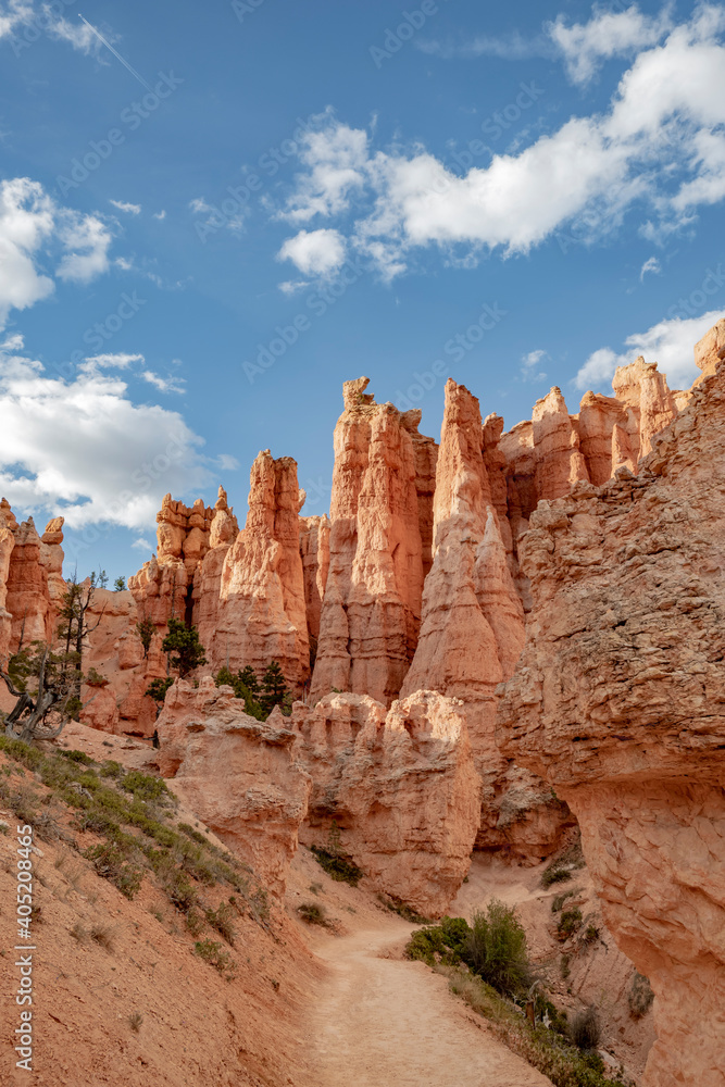 A hiking trail through the sandstone spire shaped rock formations known as hoodoos at Bryce Canyon National Park, Utah, USA.