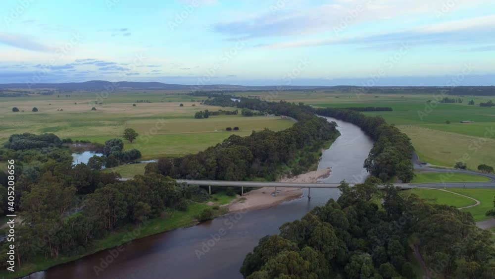 Slow rise over Snowy River and bridge revealing fields and hills in the distance Slow rise over Snowy River and bridge revealing fields and hills in the distance