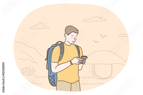 Hiking, traveling on nature, mountain tourism concept. Young happy boy cartoon character tourist backpacker hiker standing during journey and orienting on map online vector illustration 