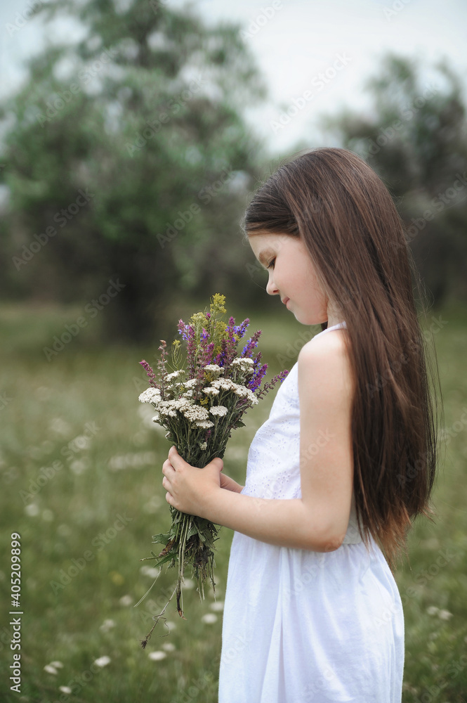 Little cute girl with flowers outdoors. Little cute girl with flowers outdoors.
