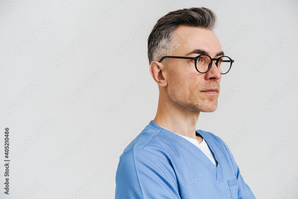 Confident white-haired medical doctor posing and looking aside Confident white-haired medical doctor posing and looking aside