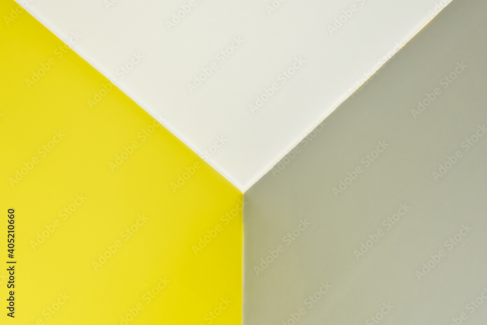 Abstract graphic background in yellow and gray colors. Straight lines on the wall, corner with three edges. three-dimensional texture. Color of the year illuminating 13-0647 and Ultimate Gray 17-5104.
