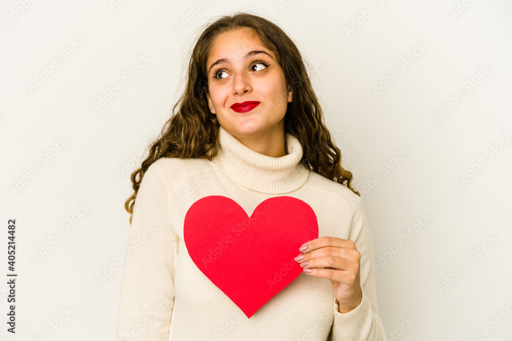 Young caucasian woman holding a heart valentines day shape isolated dreaming of achieving goals and purposes Young caucasian woman holding a heart valentines day shape isolated dreaming of achieving goals and purposes