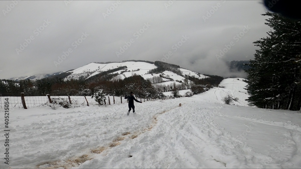 young man running in a snowed mountain