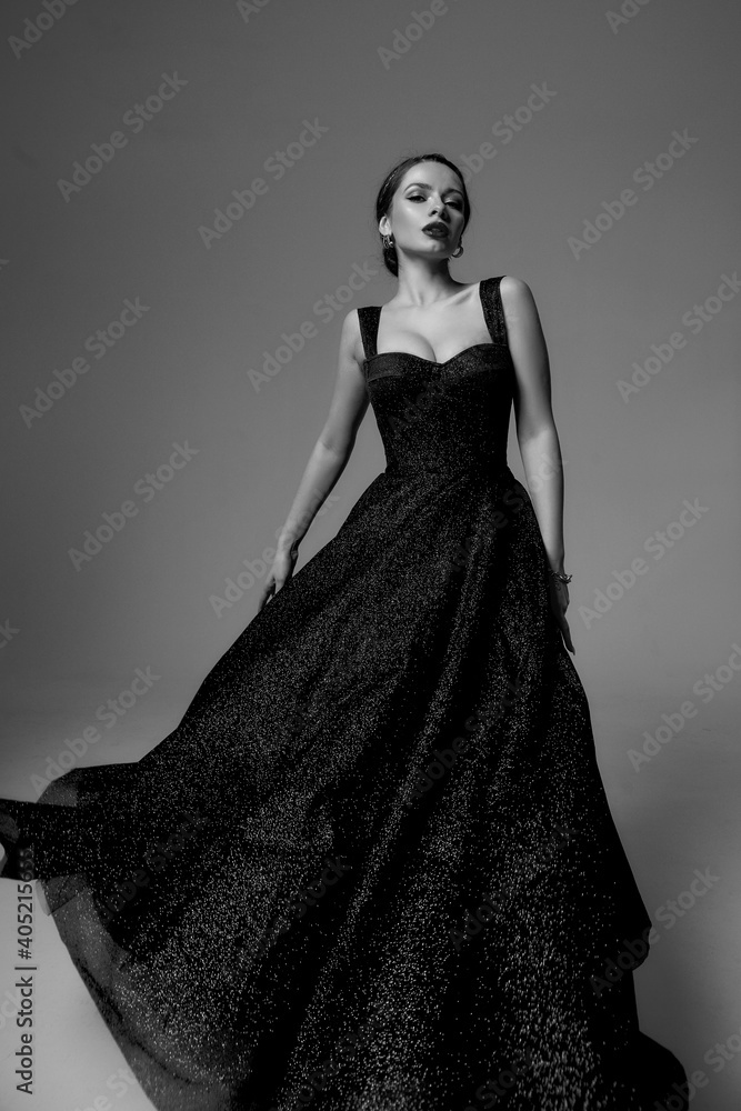 © Dmitry Tsvetkov - Full length studio fashion portrait. Elegant woman in black shiny evening dress. Dynamic shot. Fashion model with makeup and hairstyle. Caucasian brunette tall lady © Dmitry Tsvetkov - Full length studio fashion portrait. Elegant woman in black shiny evening dress. Dynamic shot. Fashion model with makeup and hairstyle. Caucasian brunette tall lady