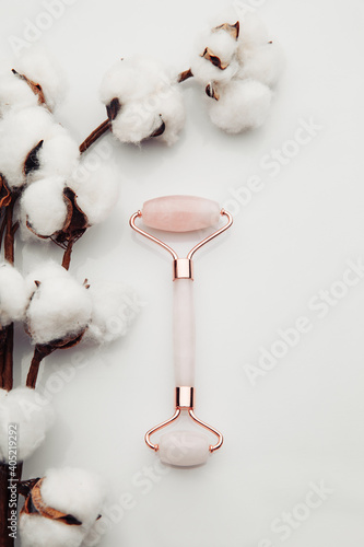 Pink jade roller for face massage. Anti age, lifting and toning treatment. Vertical image.