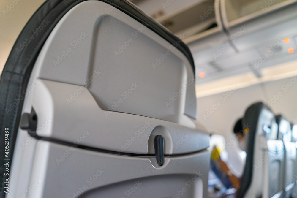 Passenger seat of plane. Soft focus and blurred background of passengers on commercial aircraft ,airplane or plane that airplane cabin interior with seats.