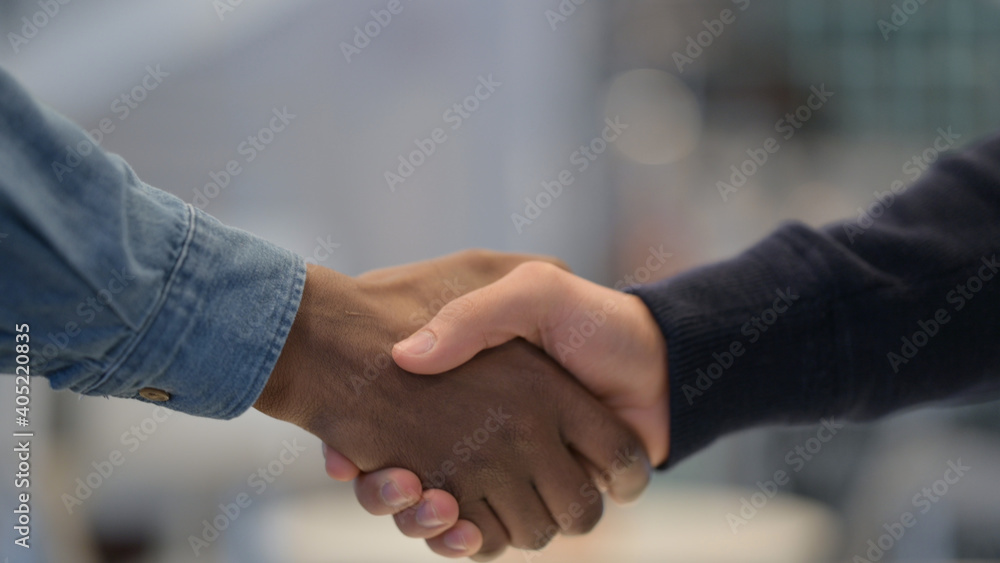 African Man and Caucasian Man Shaking Hands, Close Up African Man and Caucasian Man Shaking Hands, Close Up