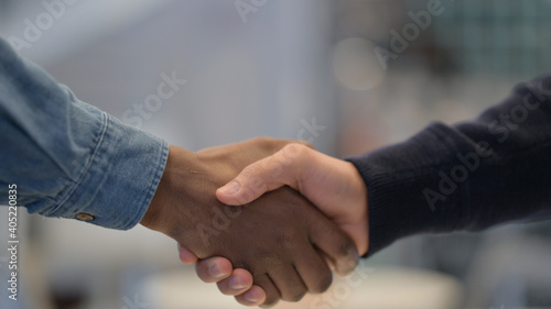 African Man and Caucasian Man Shaking Hands, Close Up 