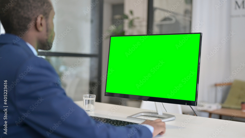 African Businessman Using Desktop with Green Chroma Key Screen 