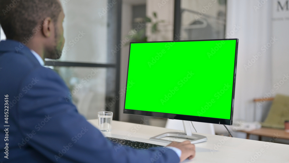 African Businessman Using Desktop with Green Chroma Key Screen African Businessman Using Desktop with Green Chroma Key Screen