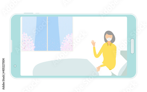オンライン面会のためにベッドで体を起こす入院患者の女性