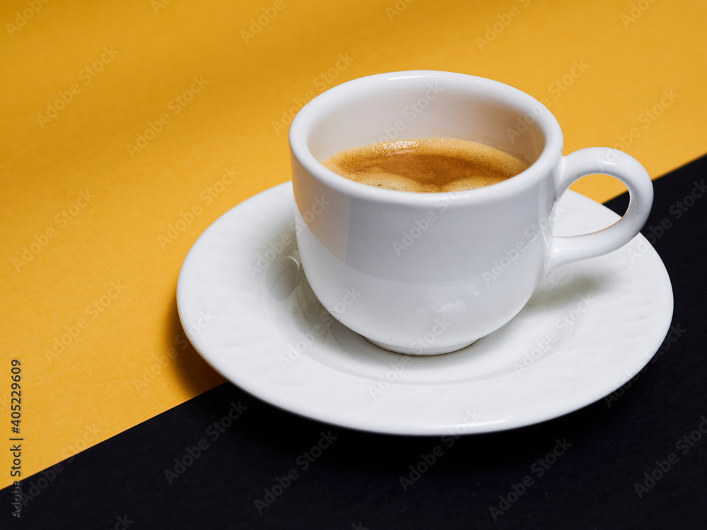 Cup of coffee with black and orange ground Cup of coffee with black and orange ground