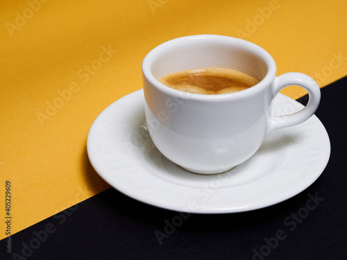 Cup of coffee with black and orange ground