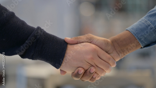 Close Up of African Man and Caucasian Man Shaking Hands
