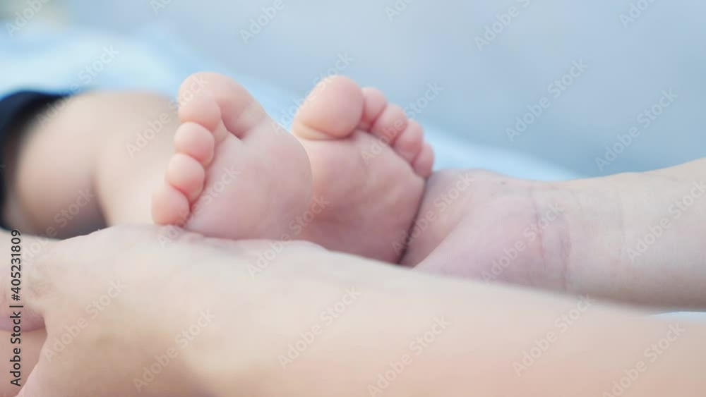legs feet baby face model a portrait. concept kid dream happy family massage care. close up legs feet little boy baby. mom holds baby love in her arms dream legs feet baby face model a portrait. concept kid dream happy family massage care. close up legs feet little boy baby. mom holds baby love in her arms dream