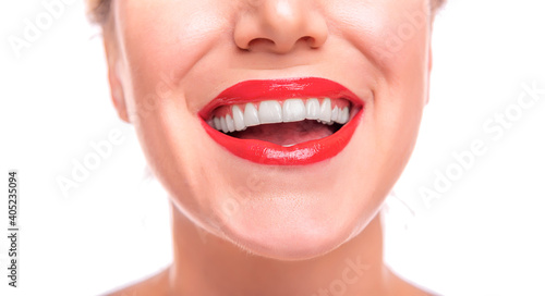 Woman s face with red lipstick on the lips and white teeth  close-up.