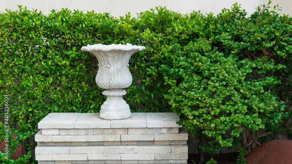 Roman style ornamental pot in the garden.