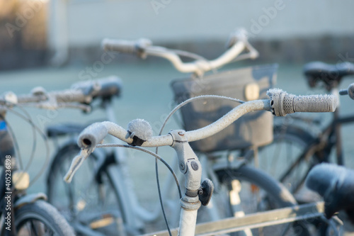 Bicycle handle bar covered in ice crystals on winter day