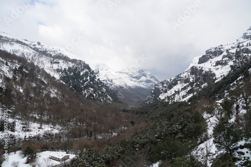 Landscape of the snowy Ason valley in winter from an aerial view located in Spain