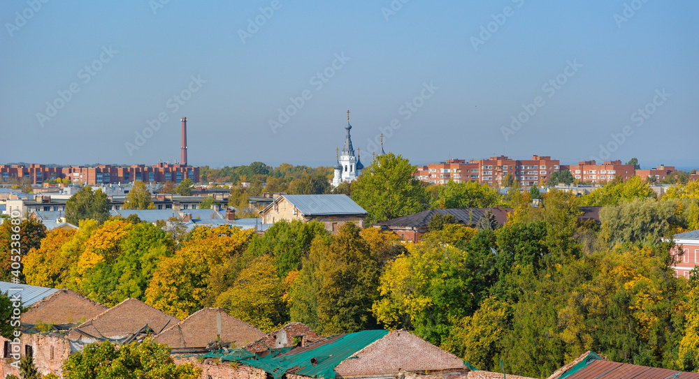 Rooftop Kronstadt view from belltower of Naval Cathedral of Saint Nicholas in golden autumn day with dam on background