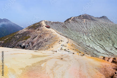 Stunning panoramic view of the Ijen Volcano Complex with mountains. Mountain landscape. A beautiful volcanic crater. People extract sulfur from the volcano. photo