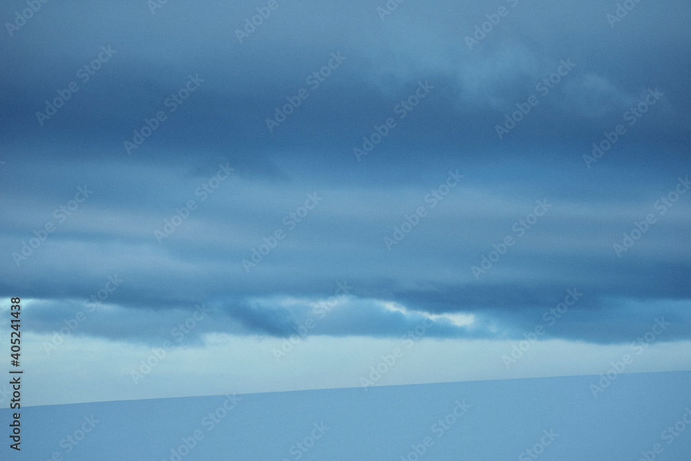 blue sky with clouds above snow covered fields in winter
