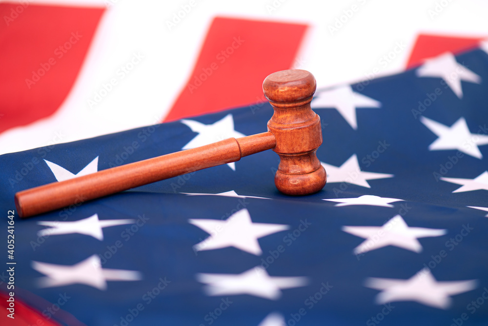 Wooden judge gavel on USA flag, conceptual image about court