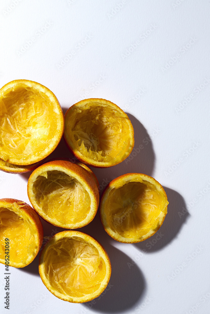 Orange peels on colorful background after being squeezed