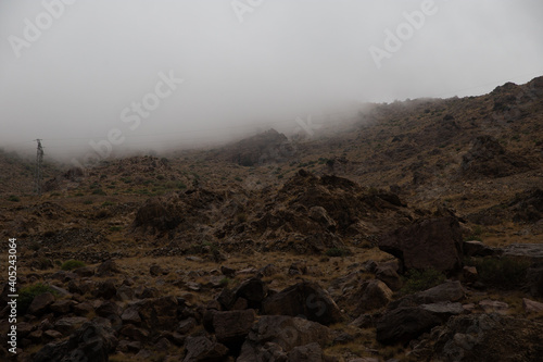The mountain rocks with foggy background on the top.