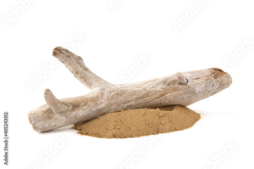 Driftwood on sand isolated on white background. Piece of coastal weathered wood on sand pile.
