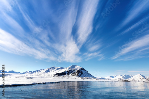 Blue sky, sea and snowy mountains in the beautiful fjords of Svalbard, Arctic Circle © Rixie