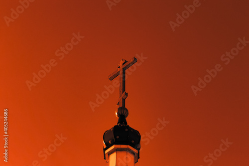 The upper part of the dome of the village Orthodox chapel, in the forest at sunset. Selective focus. photo