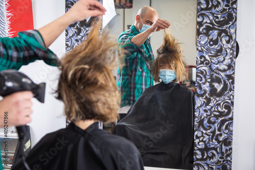 hairdresser stylist drying and styling wet hair