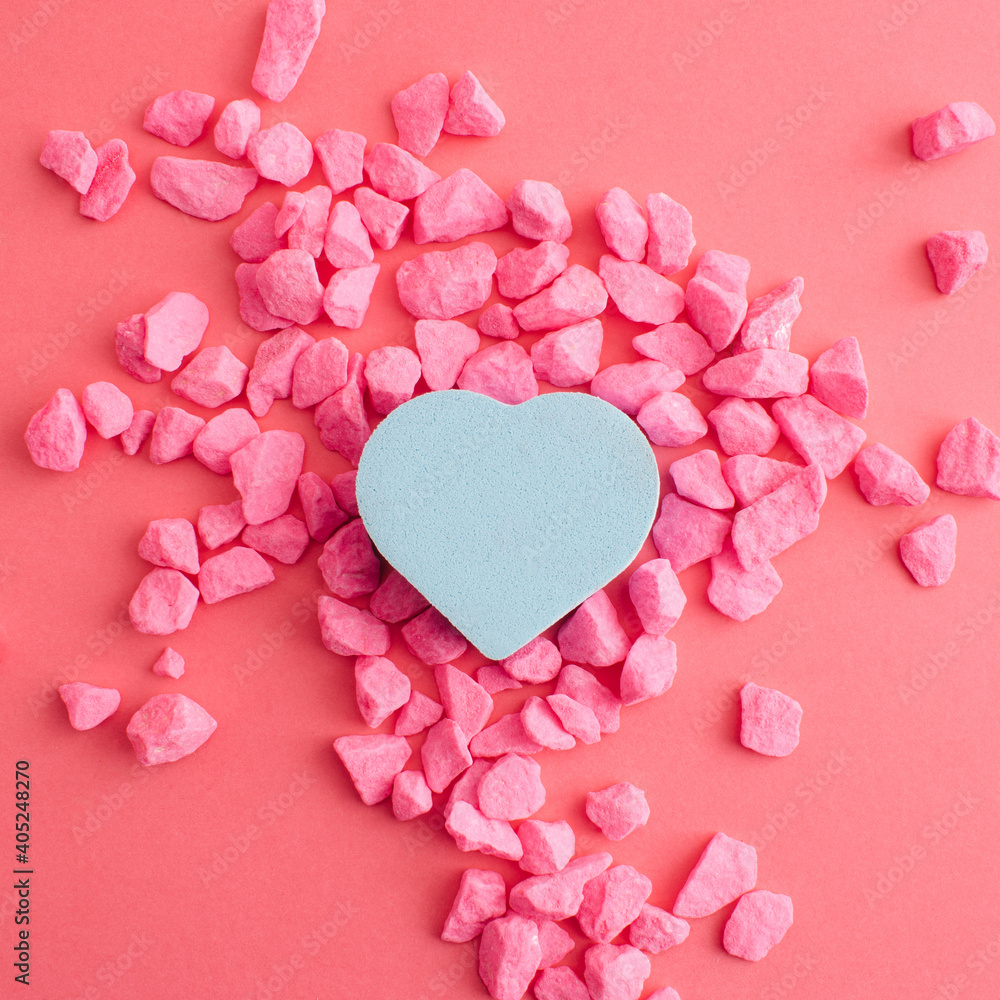 Obraz premium Blue heart and pink stones and background. Pastel decoration for valentine's day. Flat lay.