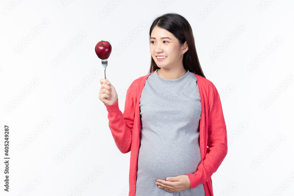 Happy pregnant young asian mother with fruits healthy food for baby and pregnant woman on white background with copy space. Healthy Food Concept. Happy pregnant young asian mother with fruits healthy food for baby and pregnant woman on white background with copy space. Healthy Food Concept.