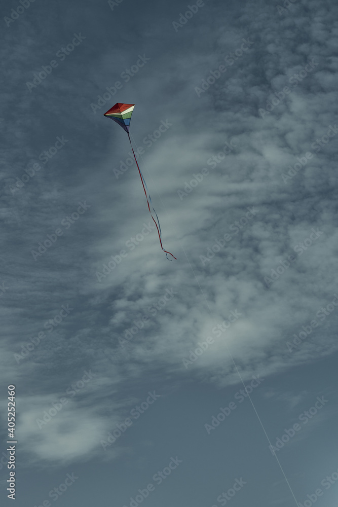 Beautiful kite in the sky against the background of clouds. Passion and hobby. Spending time in nature. Beautiful kite in the sky against the background of clouds. Passion and hobby. Spending time in nature.