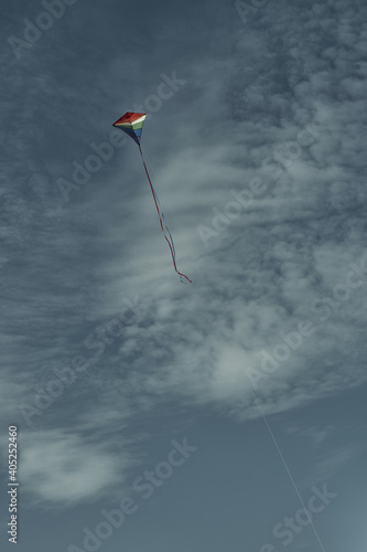 Beautiful kite in the sky against the background of clouds. Passion and hobby. Spending time in nature.