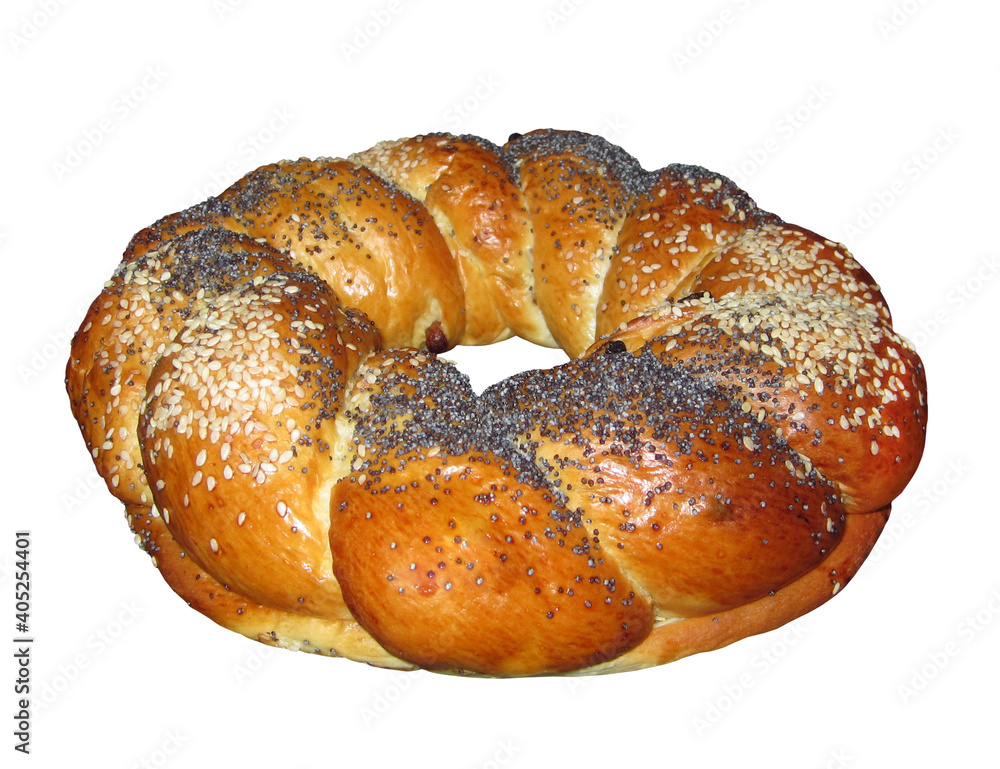 There is a round sweet bun sprinkled with poppy seeds and sesame seeds with a hole. White background. Isolated.