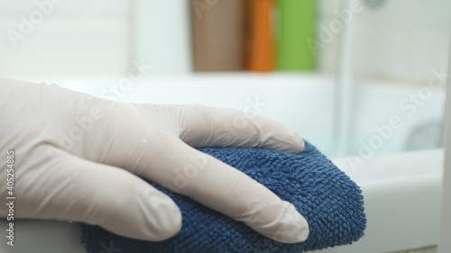 Image with a Hand Cleaning a Surface with a Blue Towel