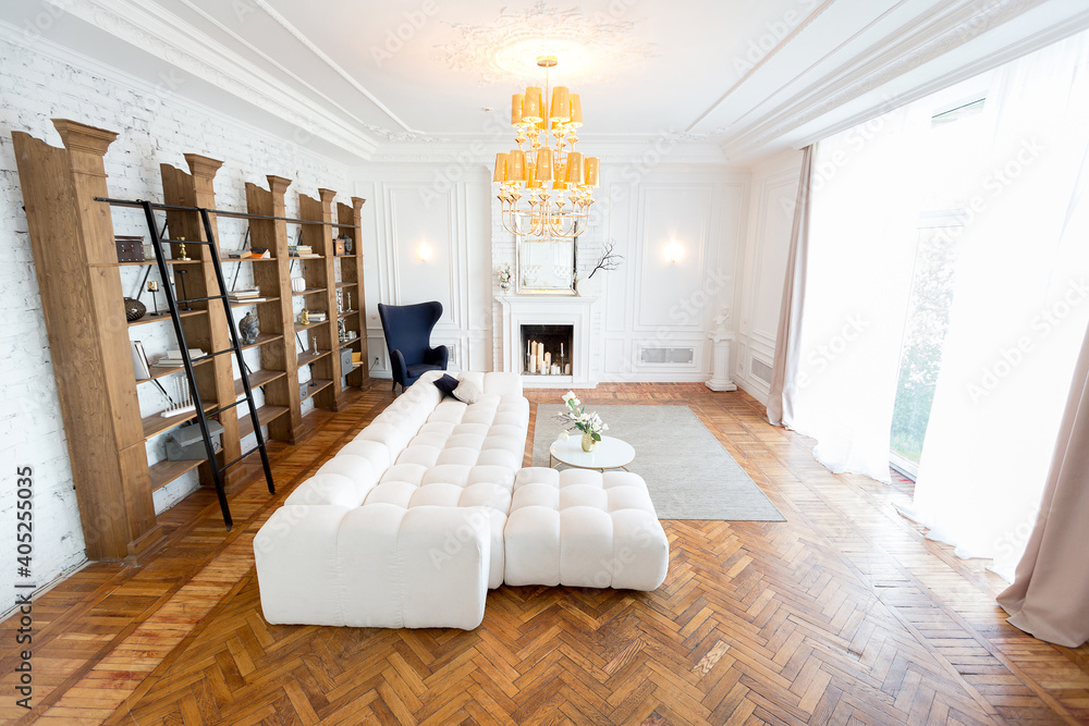modern interior of a luxurious large bright living room. white