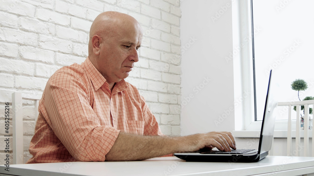Image with an Upset and Disappointed Businessman Using a Laptop