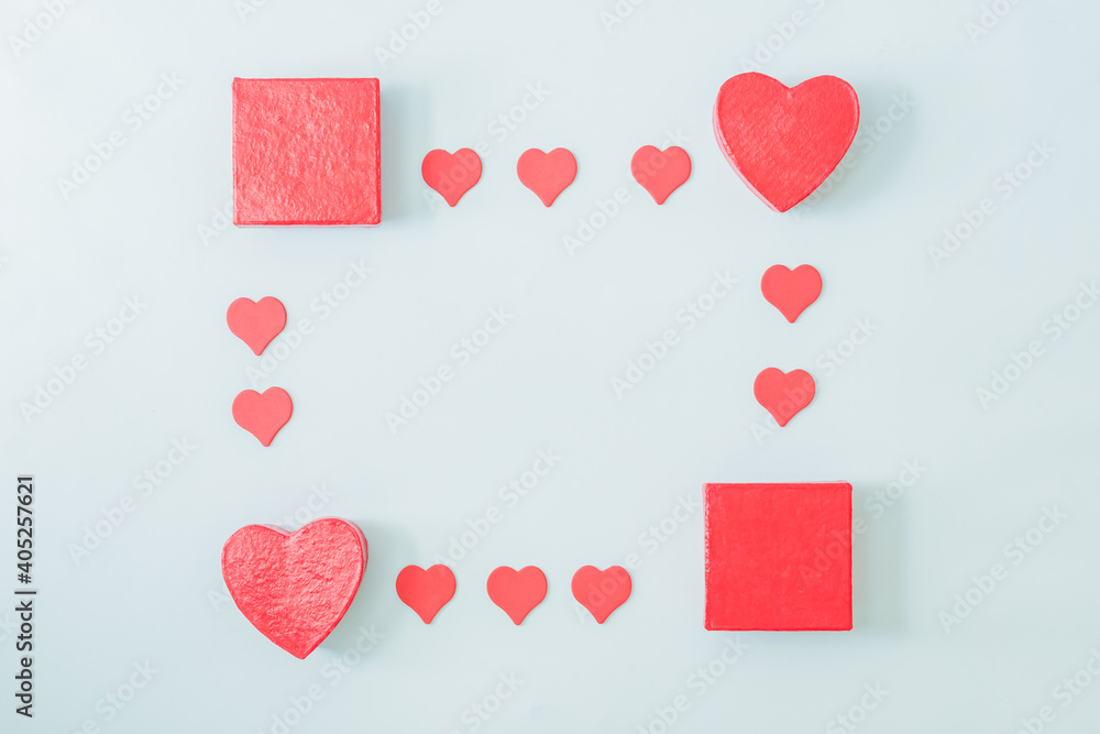 Valentines day composition with red hearts and gift box on a light background