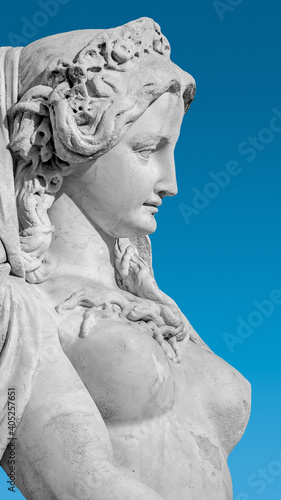 Sensual neoclassical marble statue of a noble woman in Vienna at blue gradient sky, Austria, details, closeup.