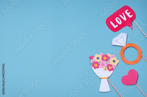 Postcard concept for Valentines  Womens Day  Mens Day  Wedding Day. Party accessories on a blue background. Flat lay  top view. Copy space.