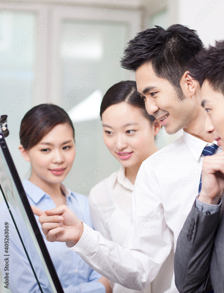 Group of business people discussing in office Group of business people discussing in office